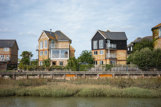 Three story town houses with balcony on a riverbank quayside in Faversham, Kent, UK