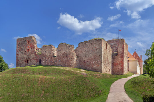 View of the ruined side of Bauska Castle in Latvia. Medieval castle architecture under a clear blue sky