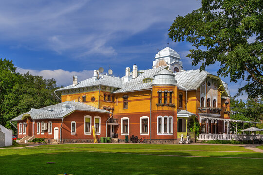 Garden view of the Ammende Villa in Parnu, Estonia. Art Nouveau hotel architecture under a partly cloudy sky