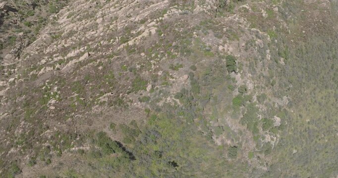 Aerial pullback of a sandstone ridge with chaparral