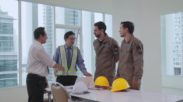 Construction worker construction plan discussion with safety helmet, hard hat, reflective vest, office teamwork, collaboration, male engineer and architect reviewing blueprints for professional