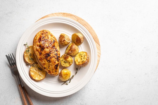 Oven roasted lemon garlic chicken and potatoes on plate