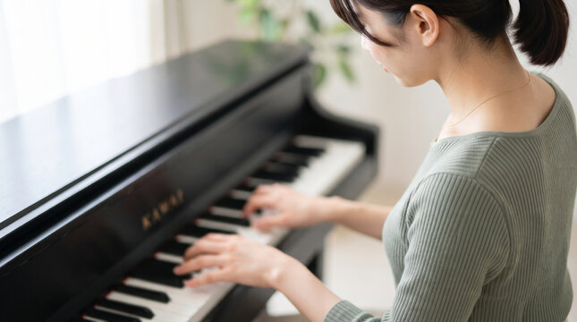 ピアノを演奏する女性の手元と鍵盤