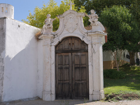 View of the ornate stone doorway of the Saint Bernard Convent in Portalegre, featuring carved figures and a wooden door, Portalegre, Portalegre District, Portugal.