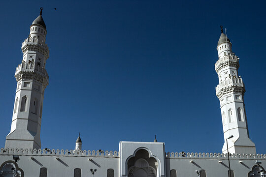 View of the white minarets of Masjid Quba against a clear blue sky in Madinah, Al Madinah Province, Saudi Arabia.