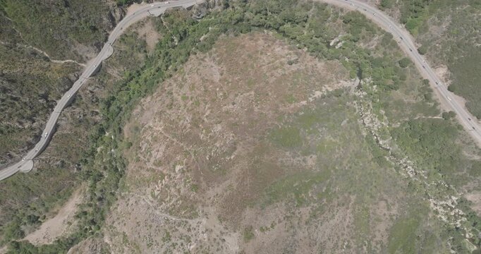 Aerial top-down view of a highway curving through a canyon