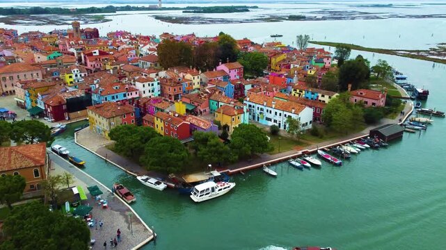Aerial view of Burano island with colorful houses, canals, and boats in the Venetian Lagoon, Venice, Veneto, Italy.