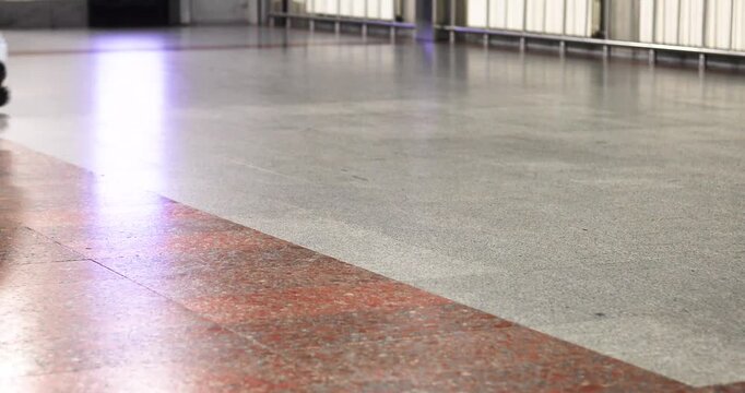 A person hurrying through the concourse of an empty train station