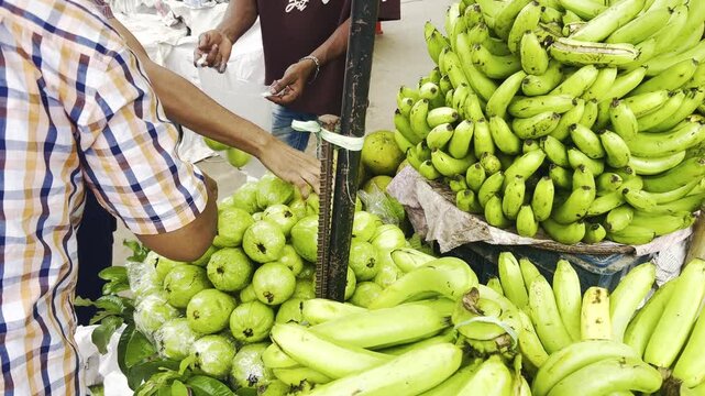 Traditional Fruit Market in Bangladesh with Customer Buying Fresh Produce