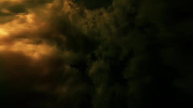Cinematic flight through dark stormy clouds with glowing golden light overlay loopable video