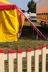 Colorful Red And Yellow Circus Tent Setup With Tension Straps At Outdoor Carnival Field © Olga