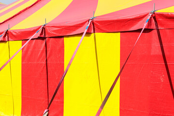 Red and Yellow Circus Tent Big Top at Outdoor Carnival Under Blue Sky © Olga