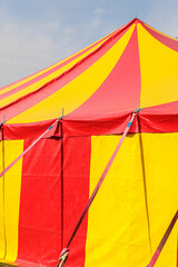 Red and Yellow Circus Tent Big Top at Outdoor Carnival Under Blue Sky © Olga