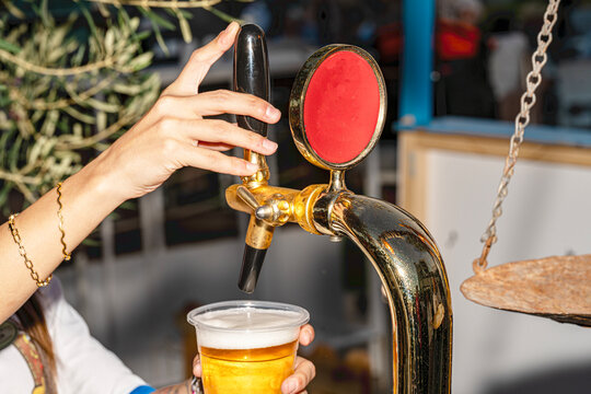 A professional beer draft machine pouring fresh lager into glass steins. Perfect for Oktoberfest festival concepts, pub bar equipment, and traditional German beer celebrations.

