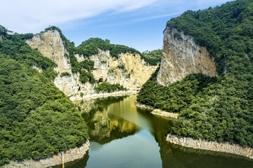 Fototapeta premium Scenic canyon river view with lush green cliffs in Bijie, Guizhou, China