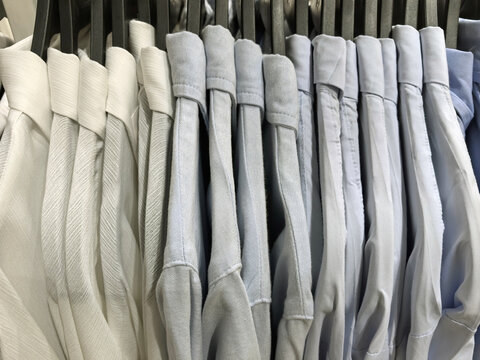 Elegant collection of neatly arranged shirts in soft hues for stylish dressing