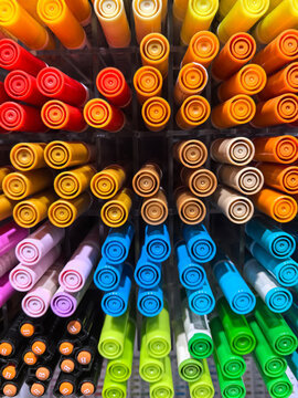 Vibrant colors on display in a craft store aisle full of markers