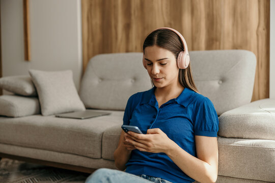 Woman relaxing at home listening to music