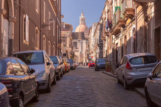 Historic Street with Cathedral Dome in Catania, Sicily, Italy