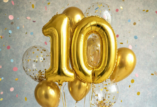 Golden Number Ten Balloon Arrangement With Confetti Decorations For Celebration