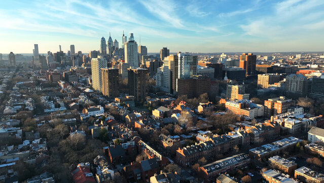 Residential district with urban city skyline during golden hour. Philadelphia Pennsylvania USA establishing shot during winter.