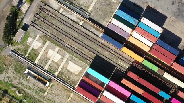 Aerial view of containers at railway. Big container terminal on a railroad with open storage area.