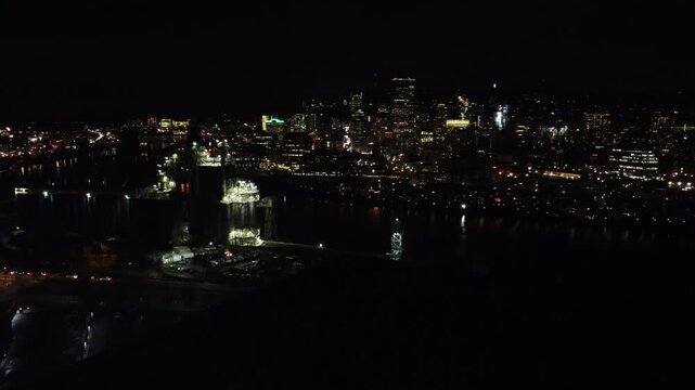 Aerial night view of the Portland skyline with illuminated buildings over the Willamette River
