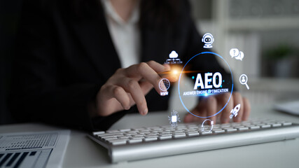 Obraz premium Professional Businesswoman Using Innovative Technology for Answer Engine Optimization with Digital Icons and Keyboard in Modern Office Environment Fluxor.