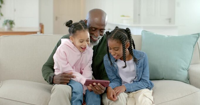 African American family on sofa senior holding pink tablet children tapping watching christmas clip