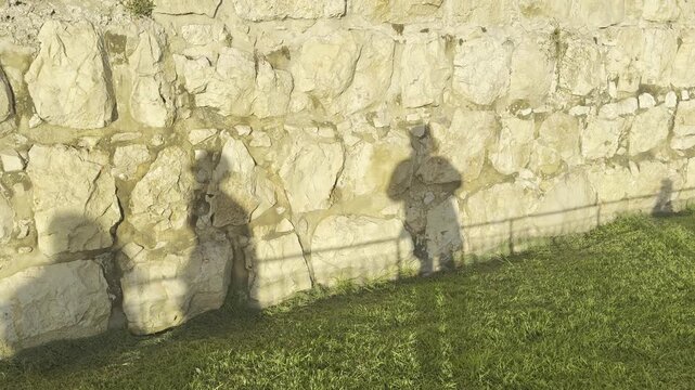 Jerusalem, Israel, 27 September 2026. Sukkot celebration, with shadows of Orthodox Jewish men moving across a wall as they dance.
