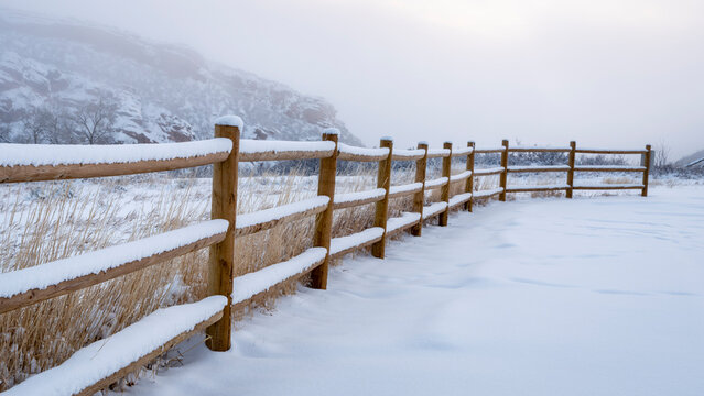 wooden fence in winter scenery of Colorado foothills
