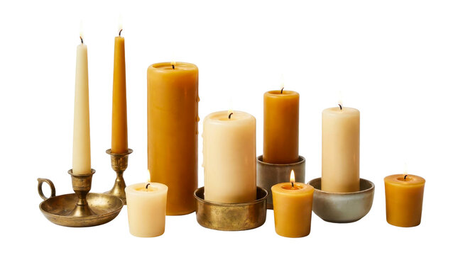 Glowing beeswax and paraffin candles in brass holders and ceramic bowls arranged together on transparent background