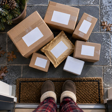 Top View of Delivery Packages at Doorstep with Slippers