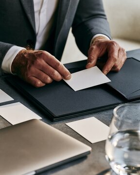HR career advisor placing blank resource card into closed folder for internal transfer