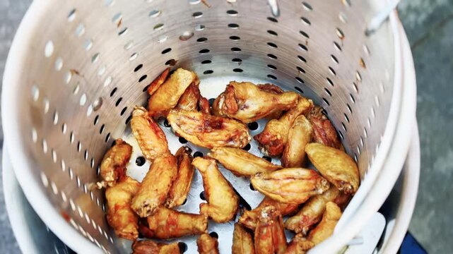 Cook Raises Crispy Chicken Wings In Fryer Basket
