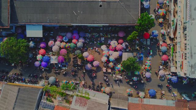 Aerial view of Pasar Pagi Pemalang market with colorful umbrellas and bustling crowds in Pemalang, Central Java, Indonesia.