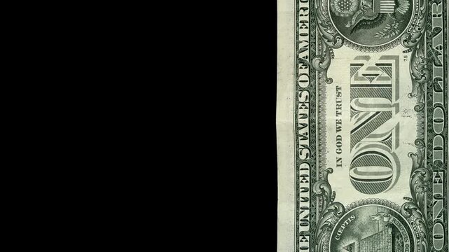Two United States one dollar bills overlapping on black background.