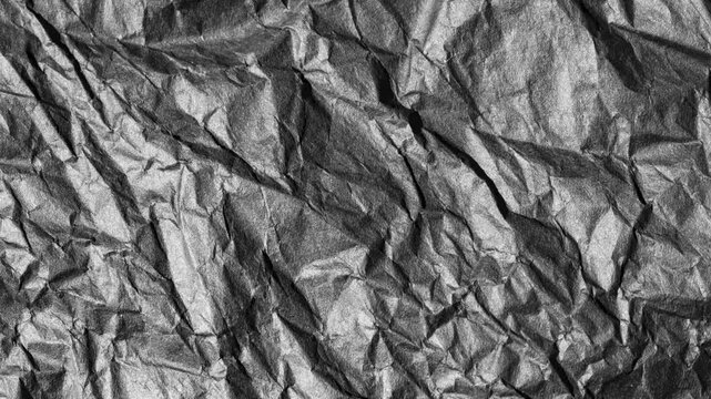 Abstract crumpled black paper texture video loop background in 4k ultra hd