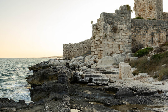 Stone ruins of Korykos land castle beside the rocky Mediterranean coast in Kizkalesi, Erdemli, Mersin Province, southern Turkey.