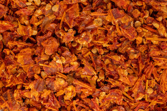 Crushed red pepper flakes creating textured spicy background