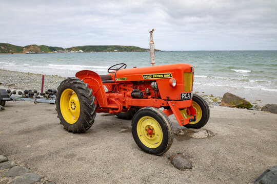 Nefyn Gwynedd Wales 19th, July, 2026 Vintage David Brown 990 Tractor Parked By Rocky Beach With Sea And Overcast Sky