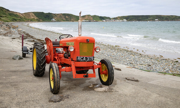 Nefyn Gwynedd Wales 19th, July, 2026 Vintage David Brown 990 Tractor Parked By Rocky Beach With Sea And Overcast Sky