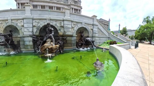 Forward view reveals Neptune, sea horses, and turtles outside the Library of Congress.
