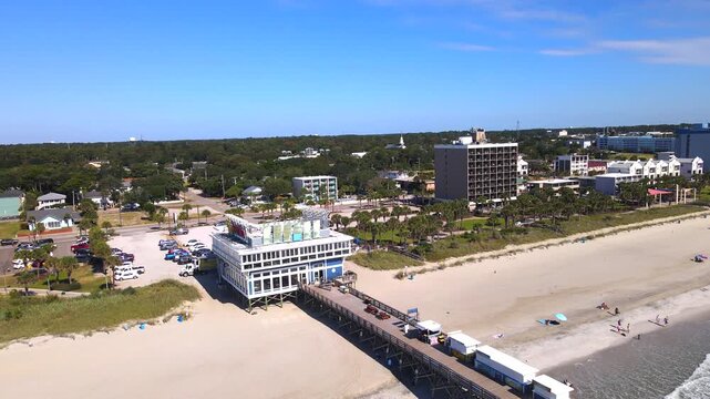 leftward camera turn reveals the connection between pier decking and beach infrastructure the Myrtle Beach .
