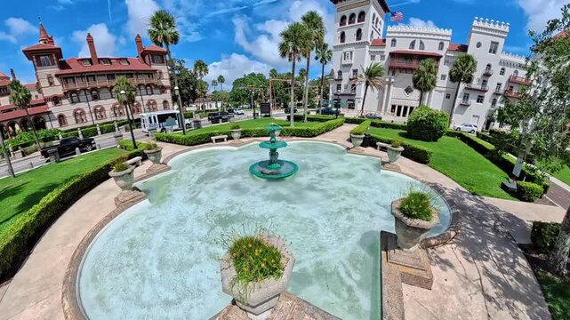 Historic plaza  Saint Augustine unfolds around a turquoise fountain beneath vivid blue summer skies.
