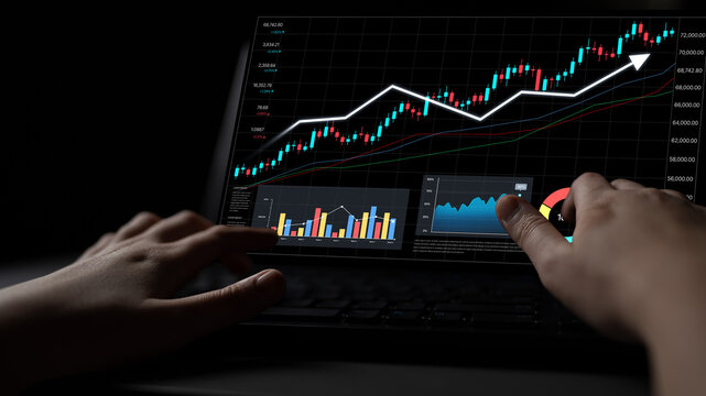 A focused trader examines stock market trends on a laptop, with charts displaying growth patterns and financial data in a sleek, modern workspace. Nascent