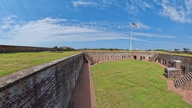 Weathered brickwork gives way to Fort Macon courtyard and a cannon on the rampart.
