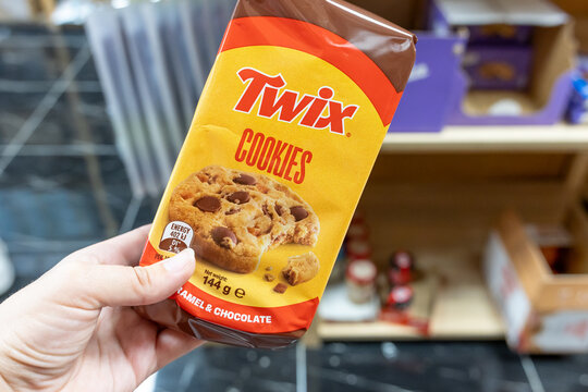Twix Cookies caramel and chocolate cookie package held by hand inside store. Kaliningrad, Kaliningrad Region, Russia. September 15, 2026.