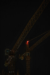 Construction cranes at night against starry sky © Kamil
