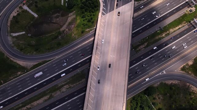 4K overhead drone video shows highway traffic beneath an overpass in Tysons, Virginia.